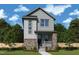 Charming two-story home featuring stone accents and gray siding nestled on a well-maintained lawn at 44 Rainfall Dr, Pittsboro, NC 27312