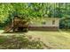 Exterior view of the home with a wooden deck and brick foundation at 441 Wintergreen Rd, Timberlake, NC 27583