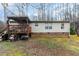 Back exterior view featuring a wooden deck and ground-level foundation at 441 Wintergreen Rd, Timberlake, NC 27583