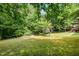 Expansive backyard with mature trees, providing ample space for outdoor activities at 441 Wintergreen Rd, Timberlake, NC 27583