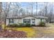 Charming single-story home with green shutters surrounded by a wooded landscape at 441 Wintergreen Rd, Timberlake, NC 27583