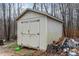 Exterior shot of a wooden shed with double doors and ample storage space at 441 Wintergreen Rd, Timberlake, NC 27583