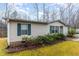 Cozy single-story home with green shutters surrounded by lush greenery at 441 Wintergreen Rd, Timberlake, NC 27583