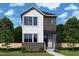 Two-story home with white siding, brick accents, professional landscaping, and a welcoming entryway at 46 Rainfall Dr, Pittsboro, NC 27312