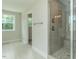 Bathroom featuring a glass-enclosed shower with a tile surround and tiled floor at 4889 Grosbeak Ct, Mebane, NC 27302
