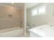 Bright bathroom featuring a tiled shower and white vanity at 4889 Grosbeak Ct, Mebane, NC 27302