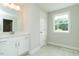 Well-lit bathroom with a large vanity, cabinet storage, and a bright window at 4889 Grosbeak Ct, Mebane, NC 27302