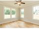 Bedroom featuring hardwood floors, crown molding, and large windows overlooking the green landscape at 4889 Grosbeak Ct, Mebane, NC 27302