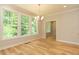 Sunlit breakfast nook with hardwood floors, and views of the surrounding greenery at 4889 Grosbeak Ct, Mebane, NC 27302