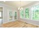Bright breakfast nook with beautiful windows, wood floors, and access to deck at 4889 Grosbeak Ct, Mebane, NC 27302