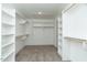 Spacious walk-in closet with built-in shelving and carpeted floor at 4889 Grosbeak Ct, Mebane, NC 27302