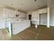 Spacious kitchen featuring an island, white cabinets, and modern fixtures, ready for customization at 4889 Grosbeak Ct, Mebane, NC 27302