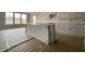 Bright kitchen with a large island, white cabinets, and abundant natural light from the windows at 4889 Grosbeak Ct, Mebane, NC 27302