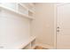 Bright mudroom features built-in bench with shelving and storage, and a white paneled door at 4889 Grosbeak Ct, Mebane, NC 27302