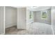 Bright bedroom showcasing soft carpet, two sunlit windows, and a closet for ample storage at 501 N 14Th St, Erwin, NC 28339