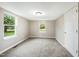 Inviting bedroom featuring two bright windows, neutral walls, soft carpet, and closet for storage at 501 N 14Th St, Erwin, NC 28339