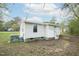 An exterior of the home with white siding and a concrete foundation, next to an AC unit and surrounded by grassy yard at 501 N 14Th St, Erwin, NC 28339