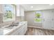 Bright kitchen features stainless steel sink, white cabinets, and new flooring at 501 N 14Th St, Erwin, NC 28339