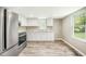 Modern kitchen featuring stainless steel appliances, white cabinets and new wood floor at 501 N 14Th St, Erwin, NC 28339