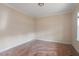 A standard sized bedroom with base molding, a window, and wood floors at 5029 Stonewood Pines Dr, Knightdale, NC 27545