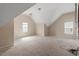 Bonus room featuring spacious area, slanted ceilings, neutral paint, and double windows at 5029 Stonewood Pines Dr, Knightdale, NC 27545
