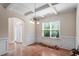 Dining room featuring coffered ceiling, chandelier, and wainscoting detail throughout at 5029 Stonewood Pines Dr, Knightdale, NC 27545