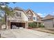 Two-story home with a mix of siding, landscaping, and an attached two car garage in need of repair at 5029 Stonewood Pines Dr, Knightdale, NC 27545