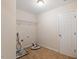 A utility room with tile floors, wire rack, and connections for a washing machine and dryer at 5029 Stonewood Pines Dr, Knightdale, NC 27545