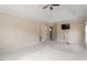 A main bedroom with tray ceiling, ceiling fan, neutral paint, and a large window at 5029 Stonewood Pines Dr, Knightdale, NC 27545