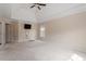 A main bedroom with tray ceiling, ceiling fan, neutral paint, and a large window at 5029 Stonewood Pines Dr, Knightdale, NC 27545