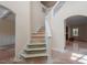 Bright staircase with white railing leading to the second floor with arches and trim at 5029 Stonewood Pines Dr, Knightdale, NC 27545