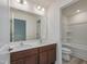 Well-lit bathroom featuring a double sink vanity and shower-tub combo at 568 Winding Creek Dr, Lillington, NC 27546