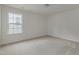 Bedroom featuring a large window, neutral carpet, and soothing white walls at 568 Winding Creek Dr, Lillington, NC 27546