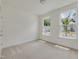 Cozy bedroom with carpet flooring and two bright windows overlooking the street at 568 Winding Creek Dr, Lillington, NC 27546