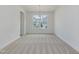 Dining room with modern chandelier, neutral carpet, and large window at 568 Winding Creek Dr, Lillington, NC 27546