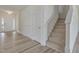 Bright foyer featuring beautiful flooring, a staircase, and a welcoming front door at 568 Winding Creek Dr, Lillington, NC 27546