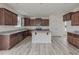 Well-equipped kitchen with island, granite countertops, and stainless steel appliances at 568 Winding Creek Dr, Lillington, NC 27546
