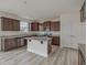 Open kitchen featuring a center island, stainless steel appliances, and wood cabinets at 568 Winding Creek Dr, Lillington, NC 27546