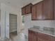 Bright kitchen featuring wood cabinets, granite countertops, and stainless steel appliances at 568 Winding Creek Dr, Lillington, NC 27546