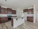 Well-equipped kitchen with island, granite countertops, and stainless steel appliances at 568 Winding Creek Dr, Lillington, NC 27546
