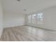 Spacious living room with light flooring and large windows at 568 Winding Creek Dr, Lillington, NC 27546