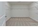 Spacious walk-in closet with shelving and neutral colored carpet flooring at 568 Winding Creek Dr, Lillington, NC 27546