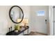 Bright foyer featuring a stylish console table, a round mirror, and a door with glass panes for natural light at 57 Black Crk Dr, Lillington, NC 27546