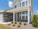 Inviting front porch with stone accents and white pillars, creating a welcoming entrance to the home at 580 Winding Creek Dr, Lillington, NC 27546