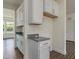 Granite countertops adorn the white cabinets in this well-lit kitchen space at 580 Winding Creek Dr, Lillington, NC 27546