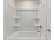 White shower tub combo with built in shelving and chrome fixtures at 580 Winding Creek Dr, Lillington, NC 27546