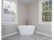 Beautiful bathroom features a freestanding tub next to bright windows at 704 Pender St, Rocky Mount, NC 27801