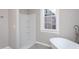 Bright bathroom features a shower, freestanding tub, and natural light at 704 Pender St, Rocky Mount, NC 27801