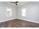 Bright, empty bedroom with hardwood floors, neutral walls, and large windows for natural light at 704 Pender St, Rocky Mount, NC 27801