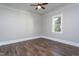 Clean bedroom with beautiful hardwood floors, neutral walls, and a bright window at 704 Pender St, Rocky Mount, NC 27801